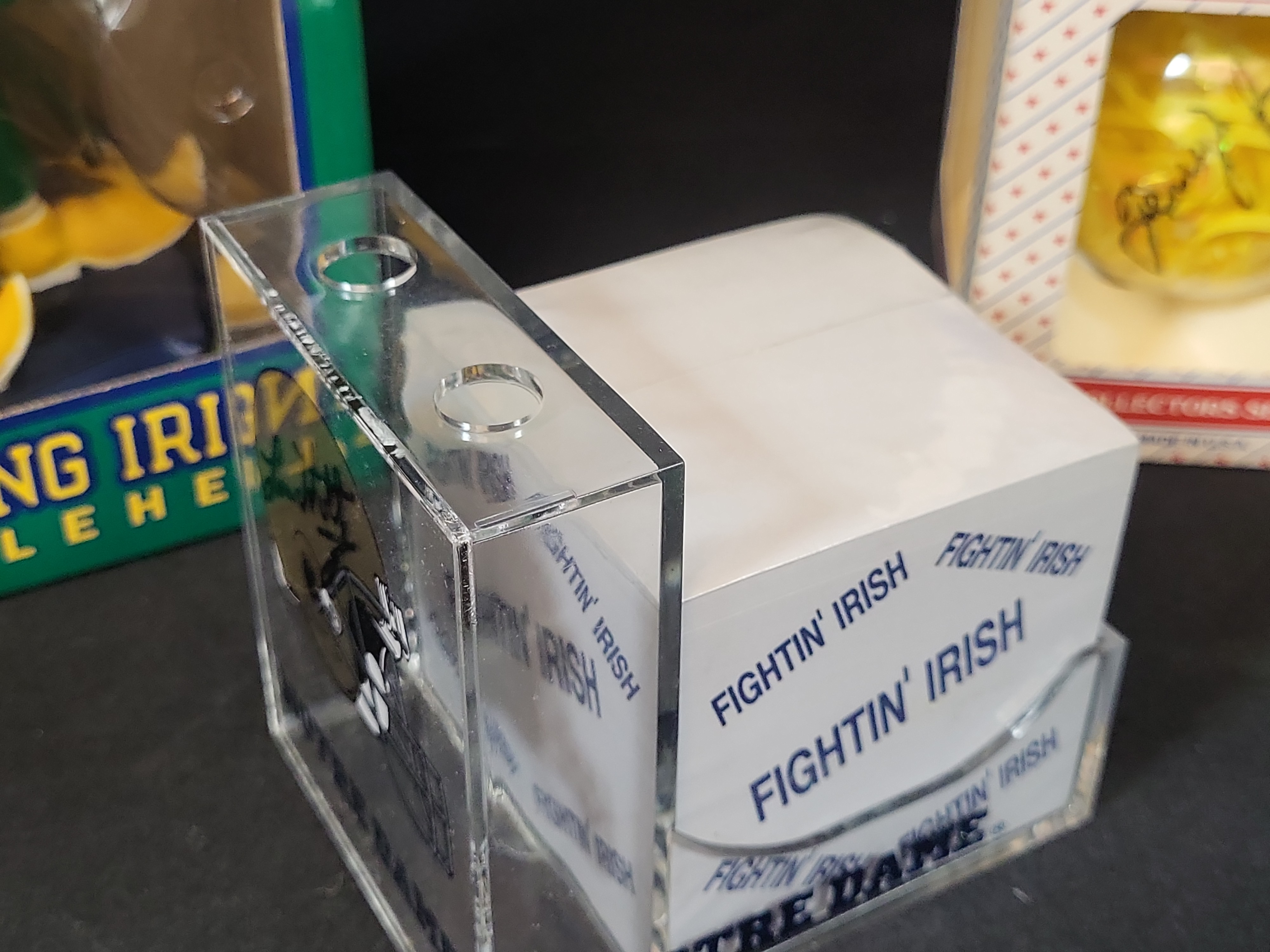 I03056 | A Collection of Four University of Notre Dame Fighting Irish Collectibles Including a Lou Holtz Signed Desk Accessory