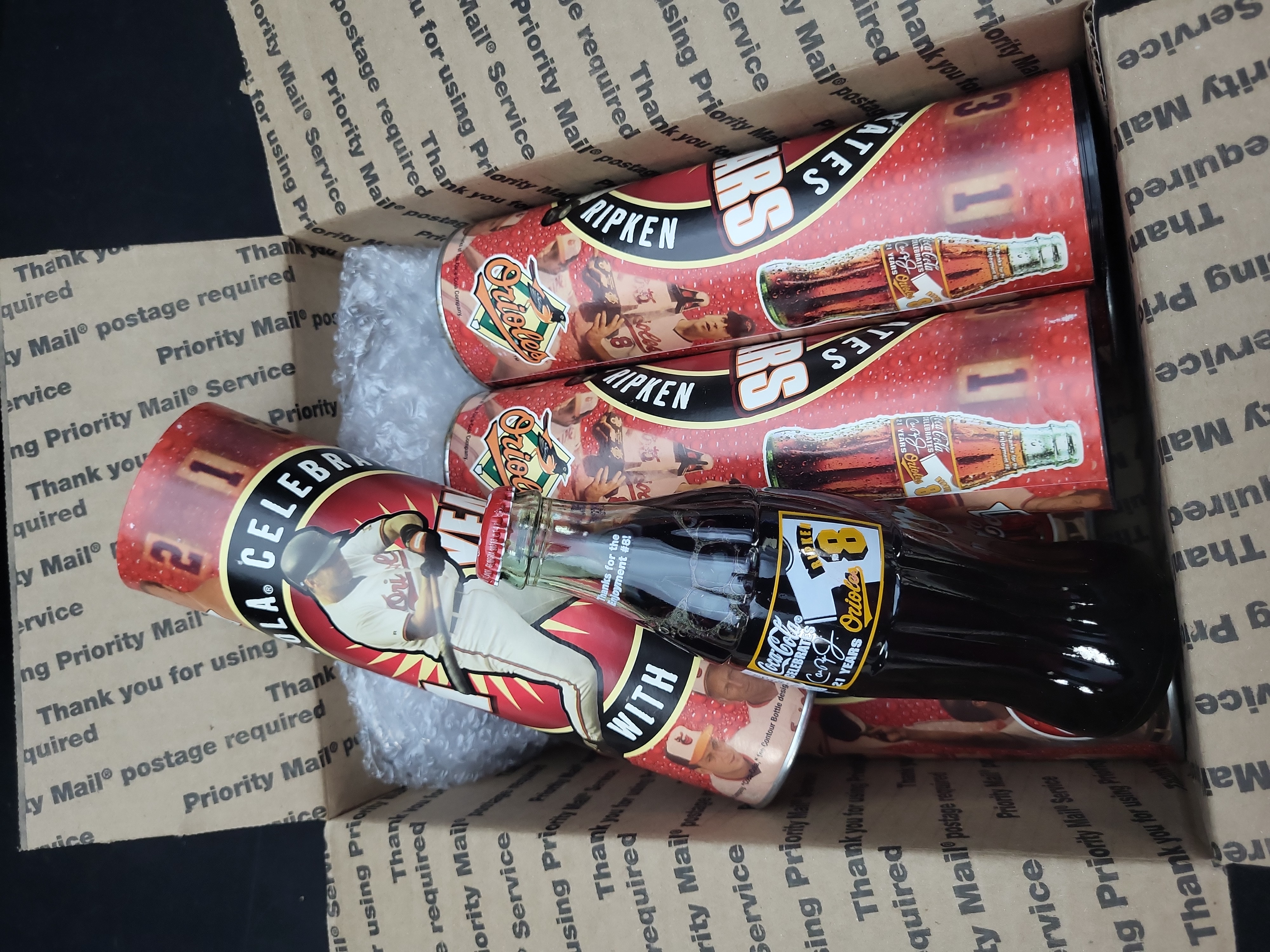 I03324 | A Collection of Cal Ripken Jr. Baltimore Orioles 21 Years Commemorative Coca-Cola Bottles and Tubes