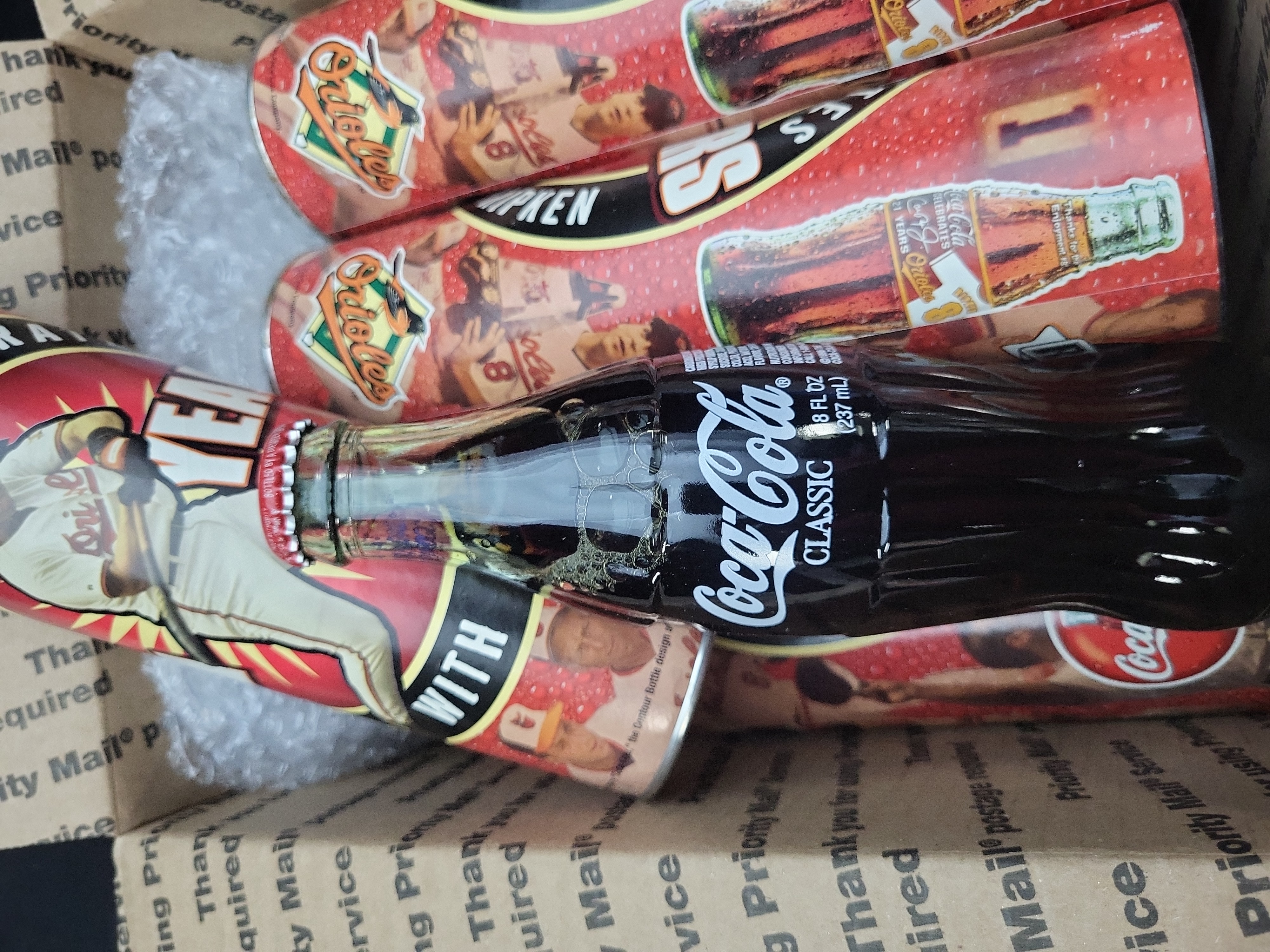 I03324 | A Collection of Cal Ripken Jr. Baltimore Orioles 21 Years Commemorative Coca-Cola Bottles and Tubes