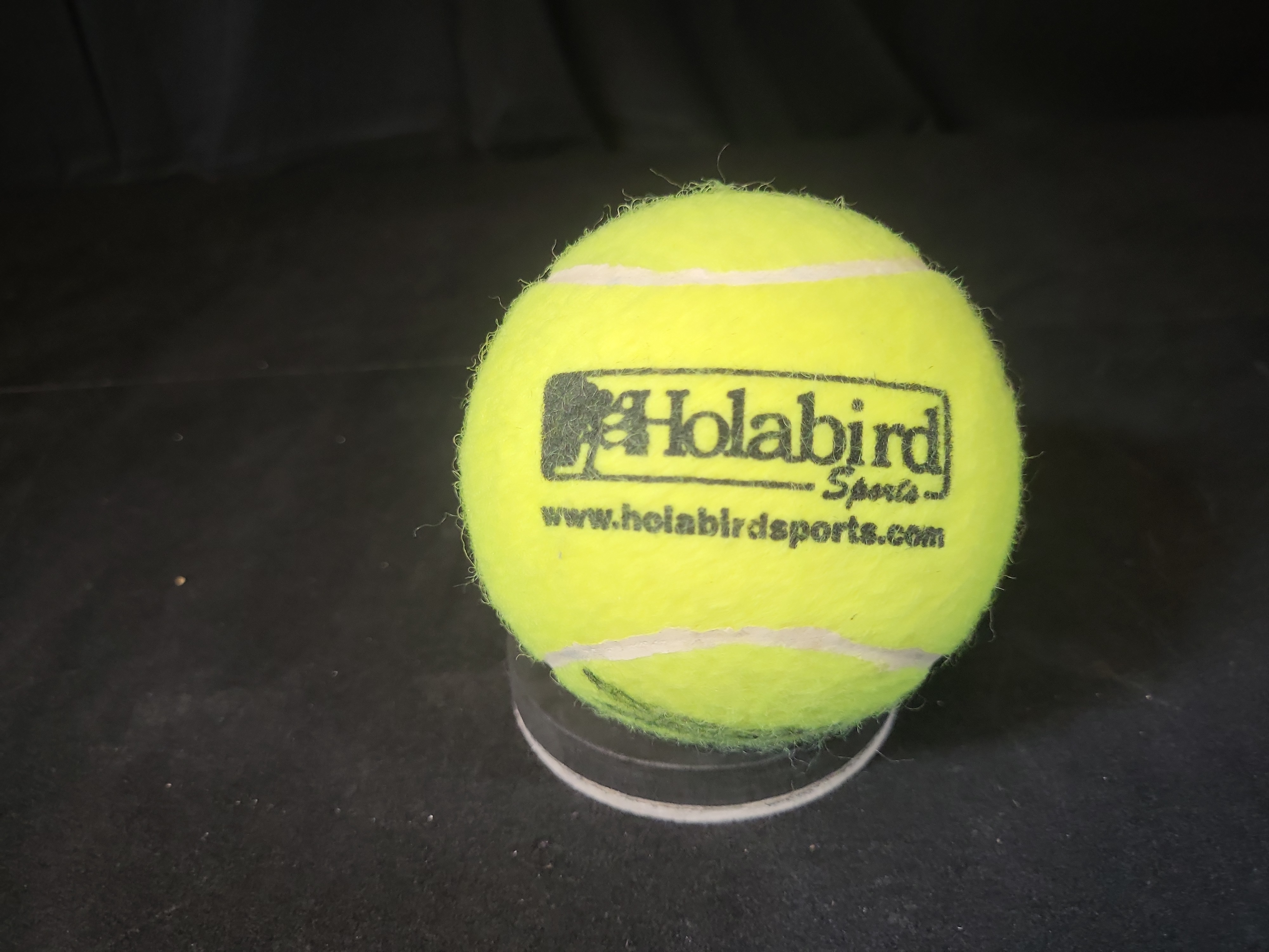 I03239 | Autographed Tennis Ball with Holabird Sports Logo and Display Stand