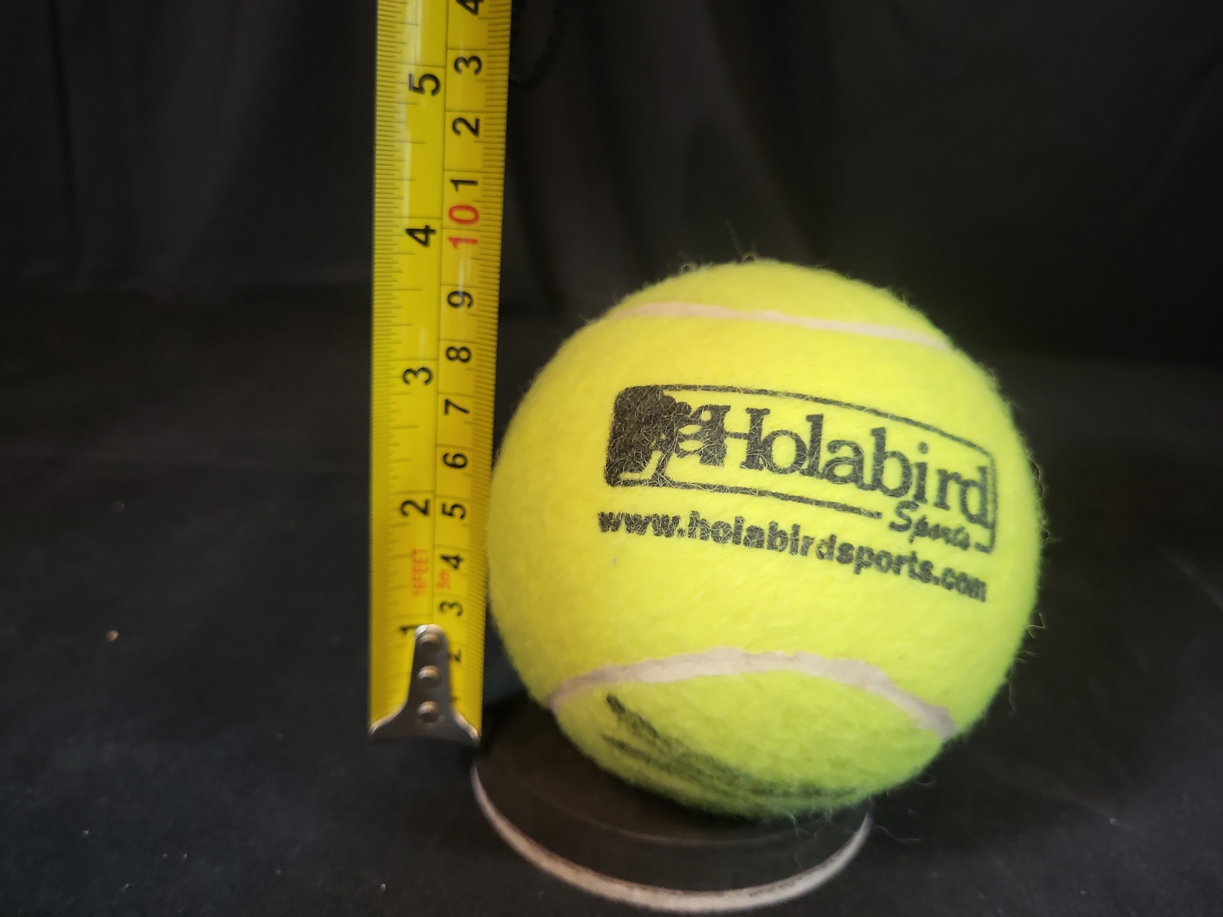 I03239 | Autographed Tennis Ball with Holabird Sports Logo and Display Stand