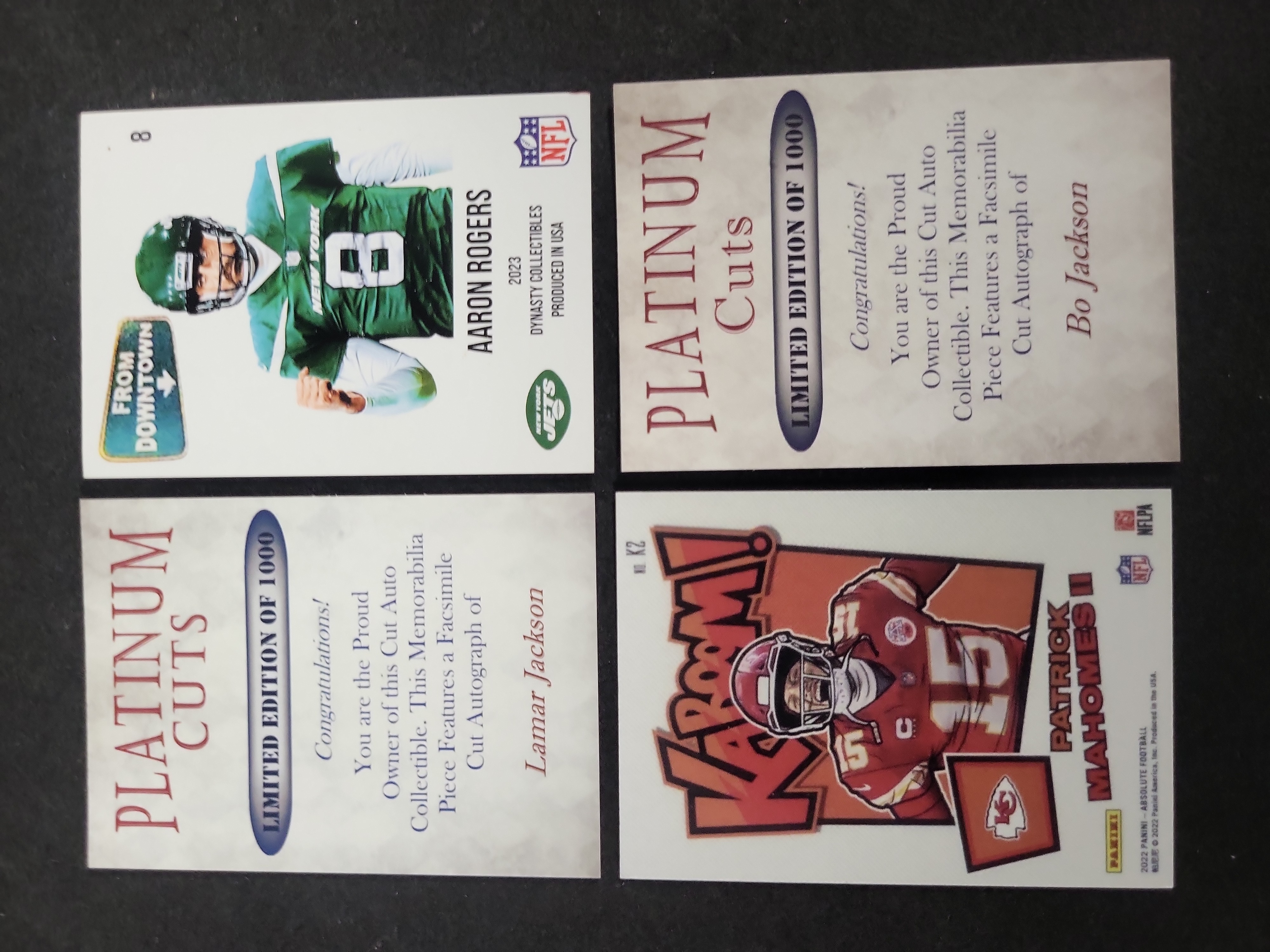 I03602 | A Collection of Four Modern Football Trading Cards Featuring Aaron Rodgers, Patrick Mahomes II, Bo Jackson, and Lamar Jackson