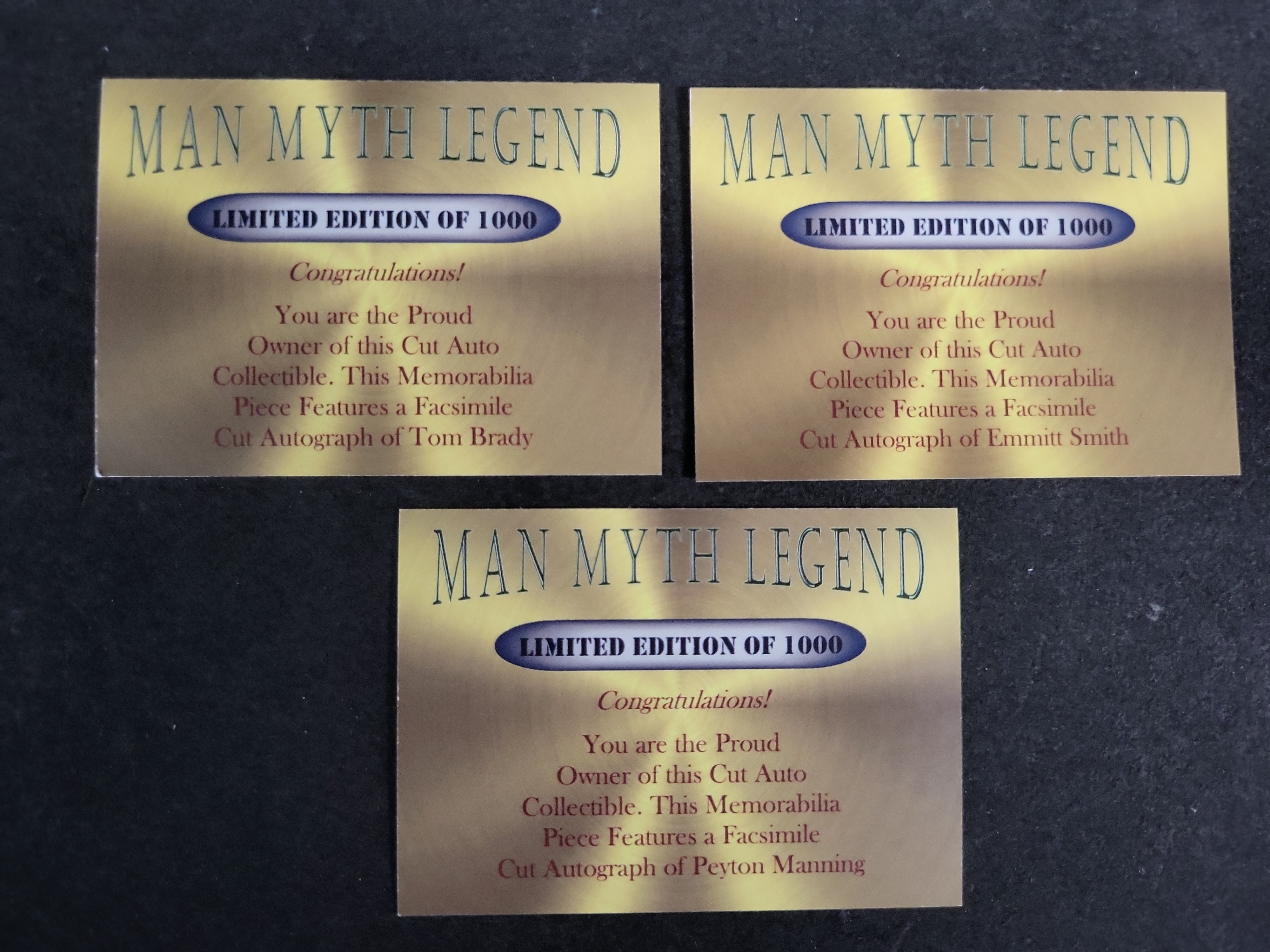 I03593 | A Trio of Man-Myth-Legend Football Cards Featuring Facsimile Cut Autographs of Tom Brady Emmitt Smith and Peyton Manning