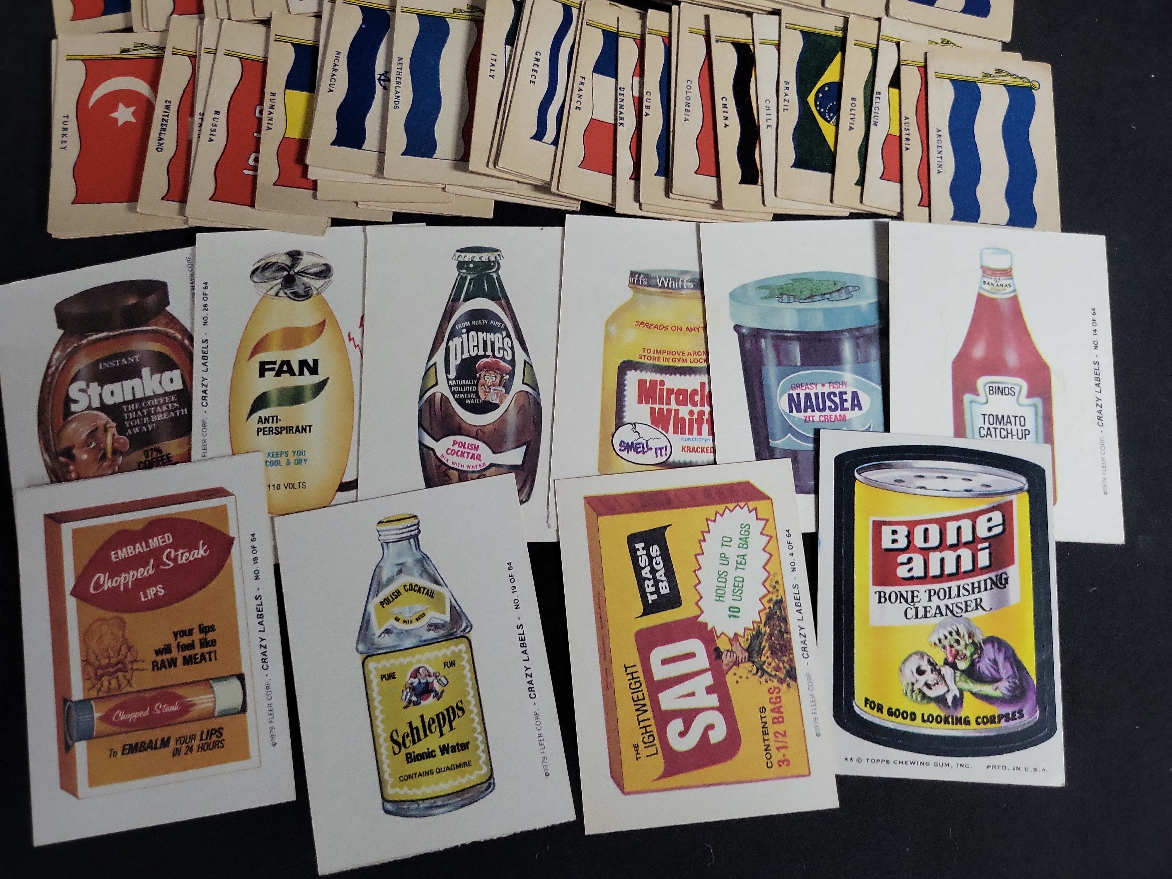 I03448 | A Collection of Vintage National Flag Cards and 1970s Parody Sticker Cards Including Topps Wacky Packages and Fleer Crazy Labels