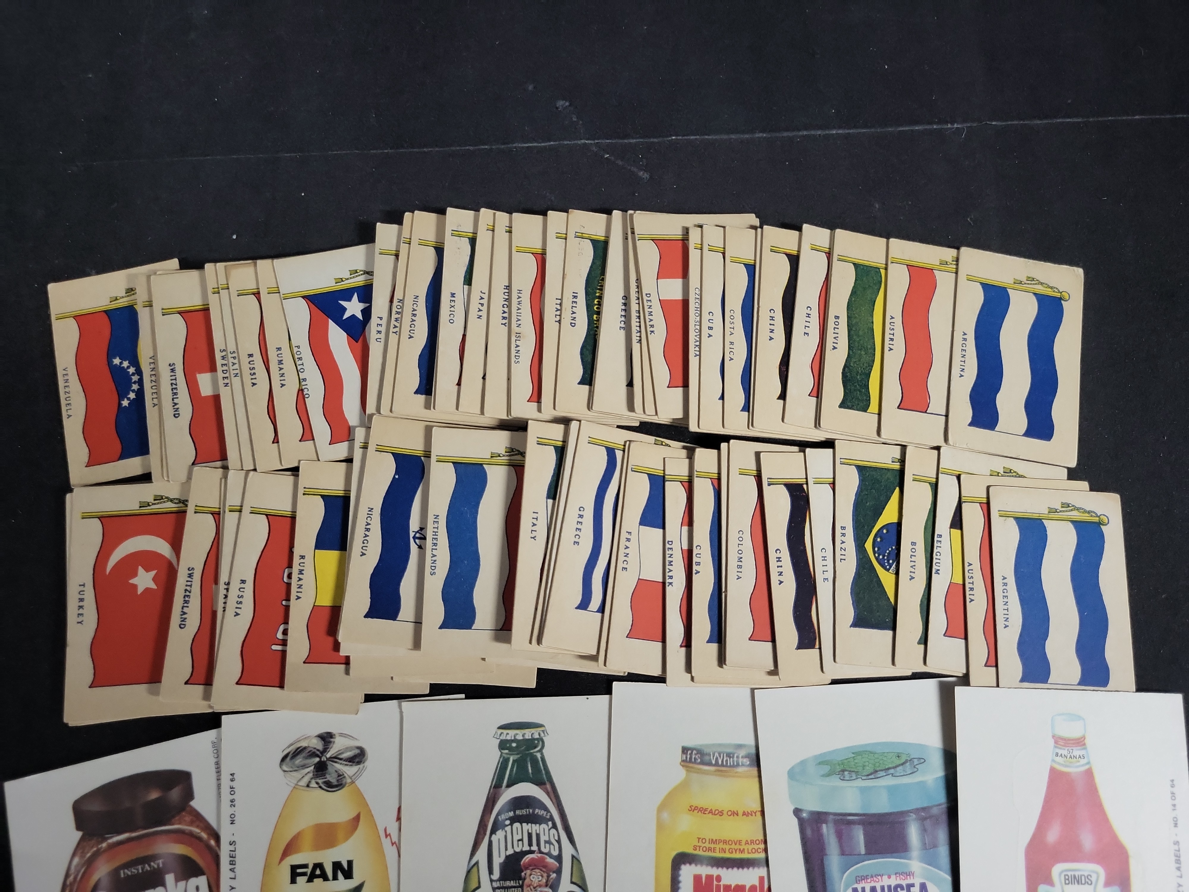 I03448 | A Collection of Vintage National Flag Cards and 1970s Parody Sticker Cards Including Topps Wacky Packages and Fleer Crazy Labels