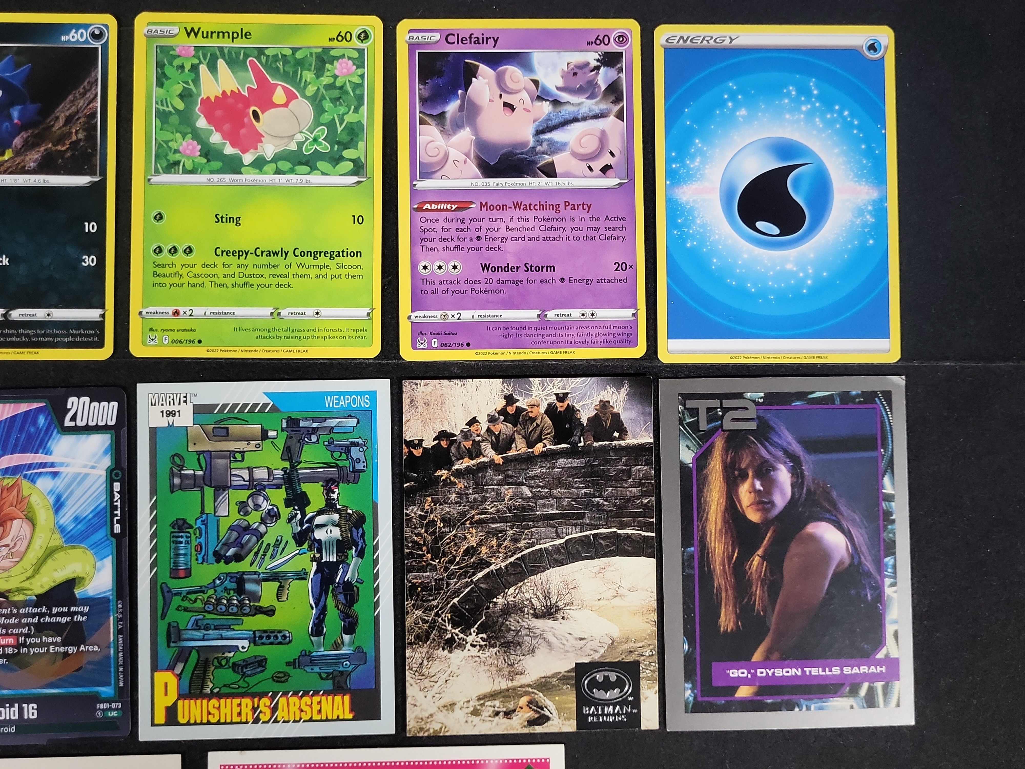 I03168 | An Assortment of 14 Trading and Collectible Cards Including Pokemon, Marvel, and Film Properties