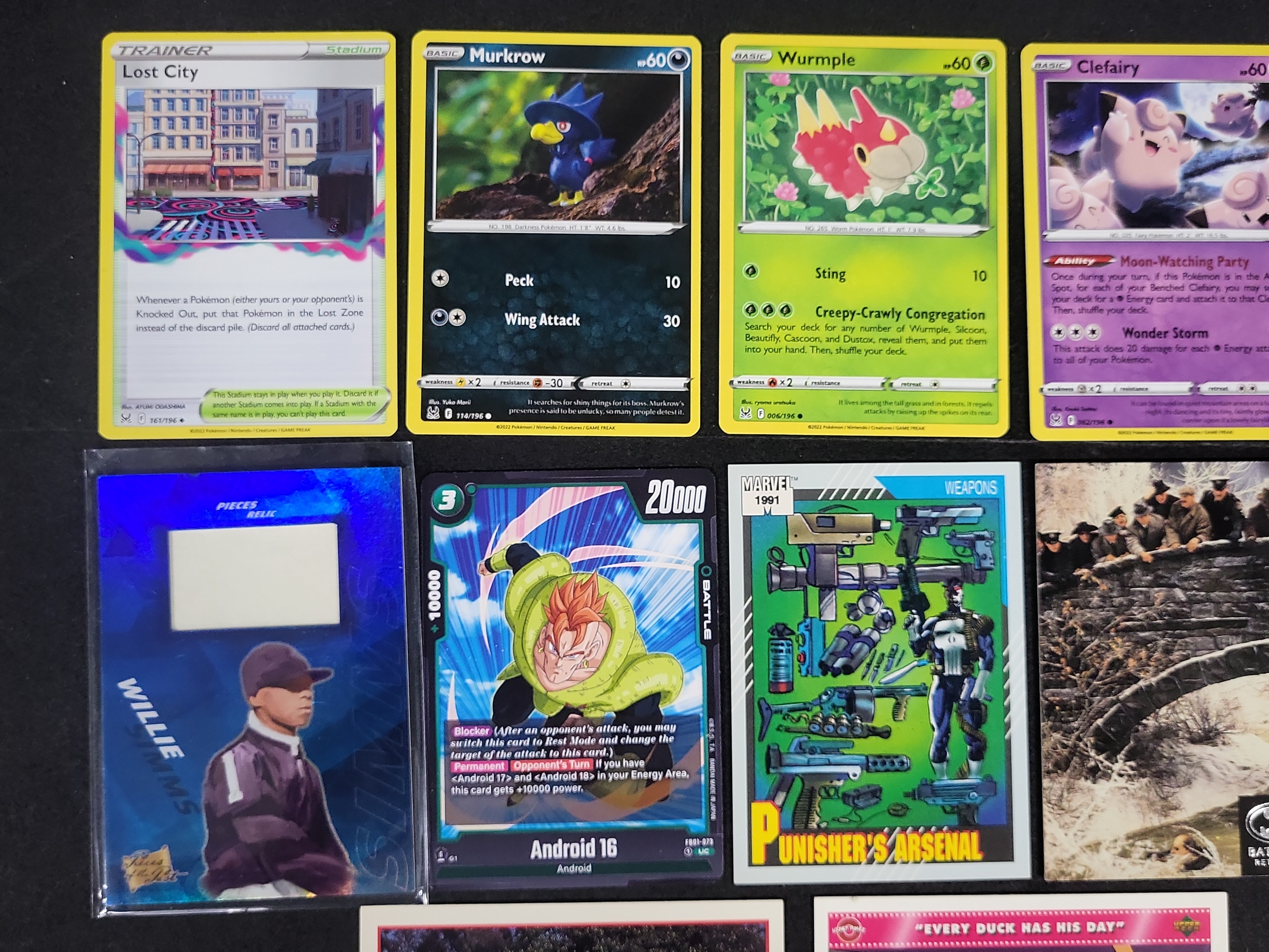I03168 | An Assortment of 14 Trading and Collectible Cards Including Pokemon, Marvel, and Film Properties