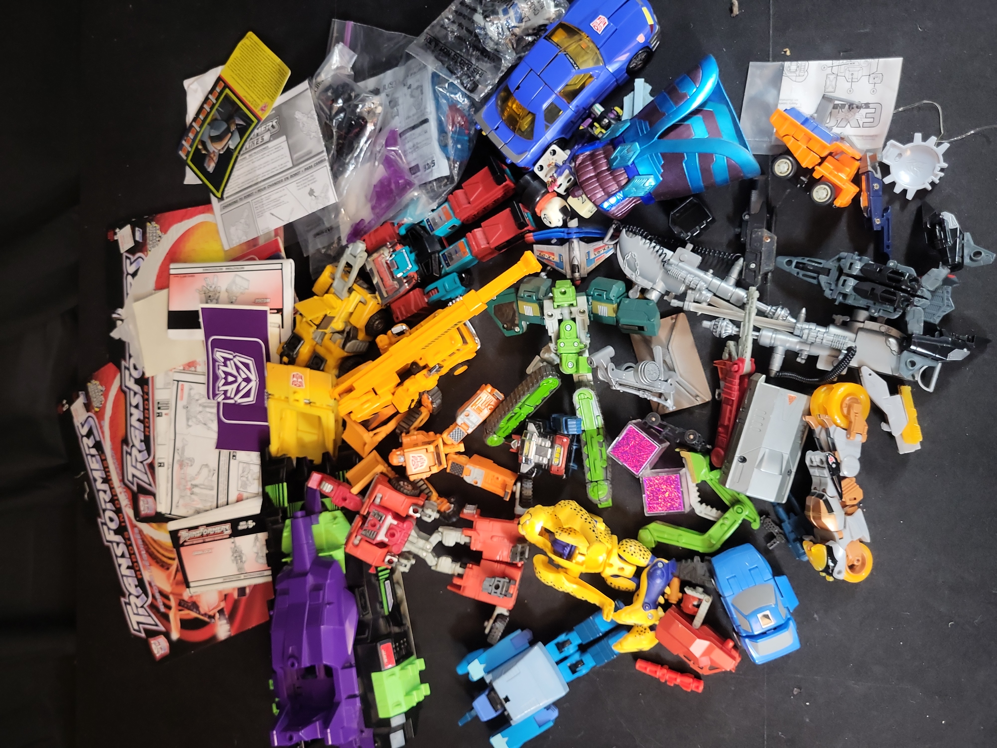 I03506 | A Collection of Vintage and Modern Hasbro and Takara Transformers Action Figures Accessories and Ephemera