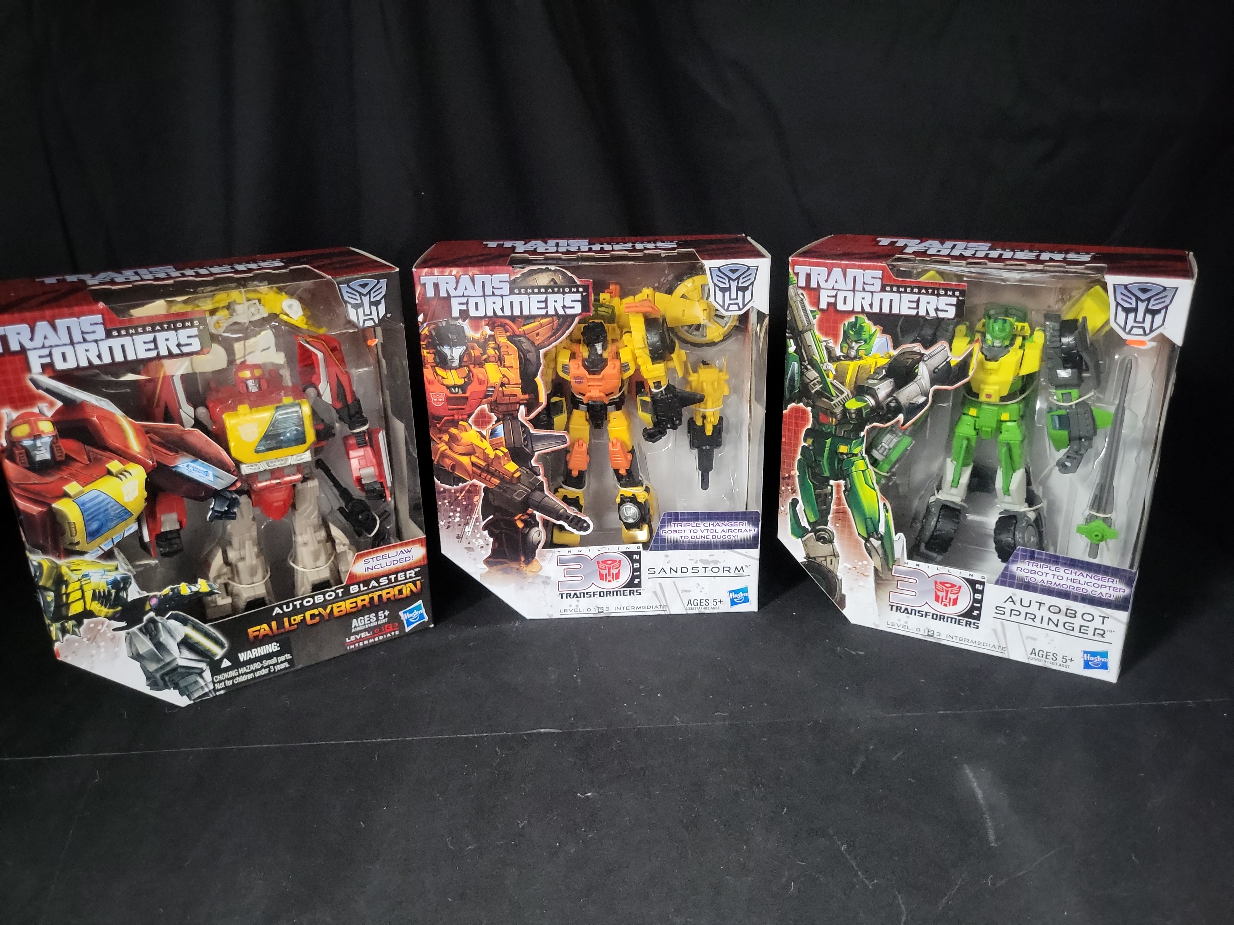 I03538 | Three Hasbro Transformers Generations Voyager Class Action Figures Including Autobot Blaster Sandstorm and Autobot Springer