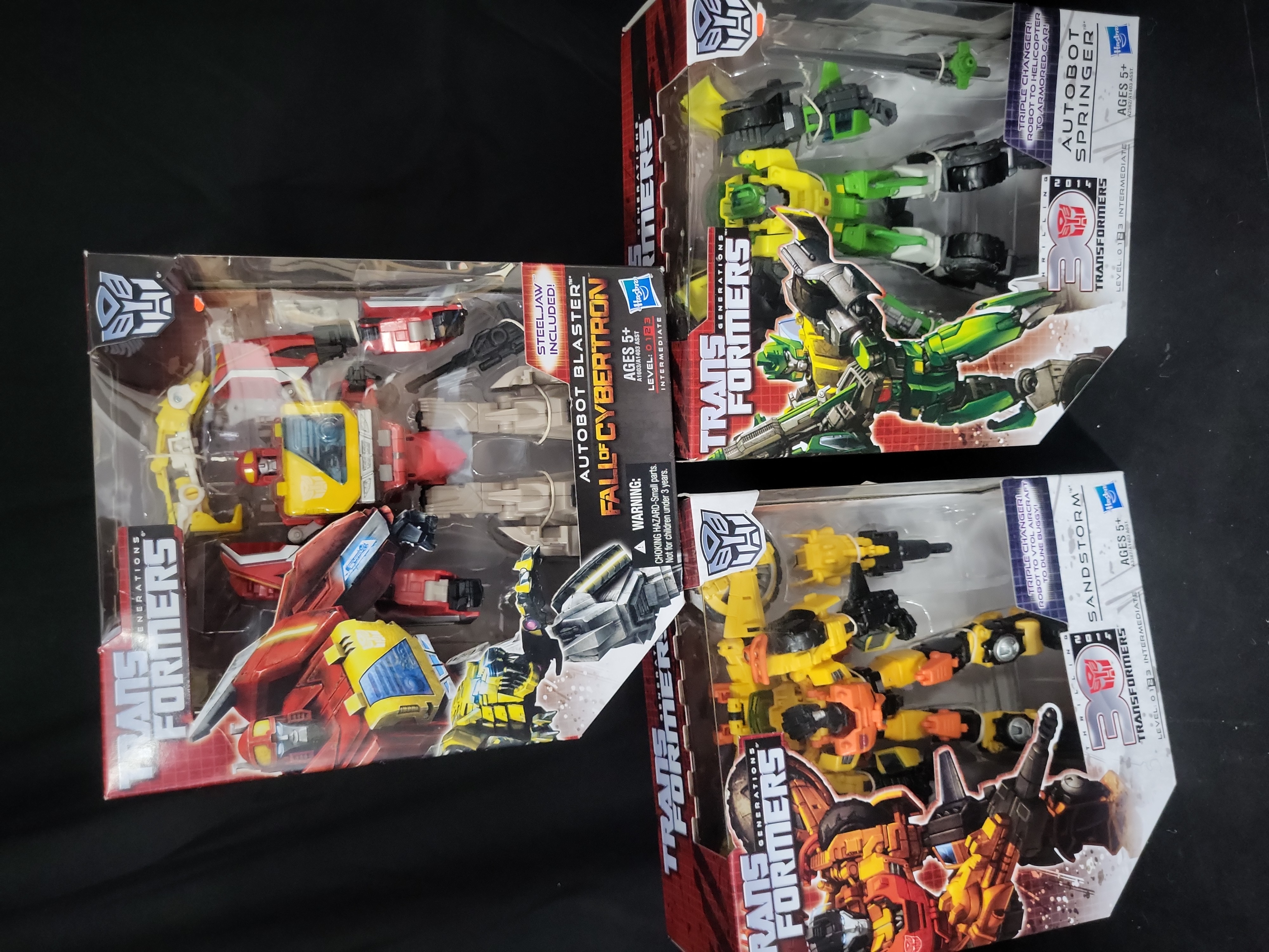 I03538 | Three Hasbro Transformers Generations Voyager Class Action Figures Including Autobot Blaster Sandstorm and Autobot Springer