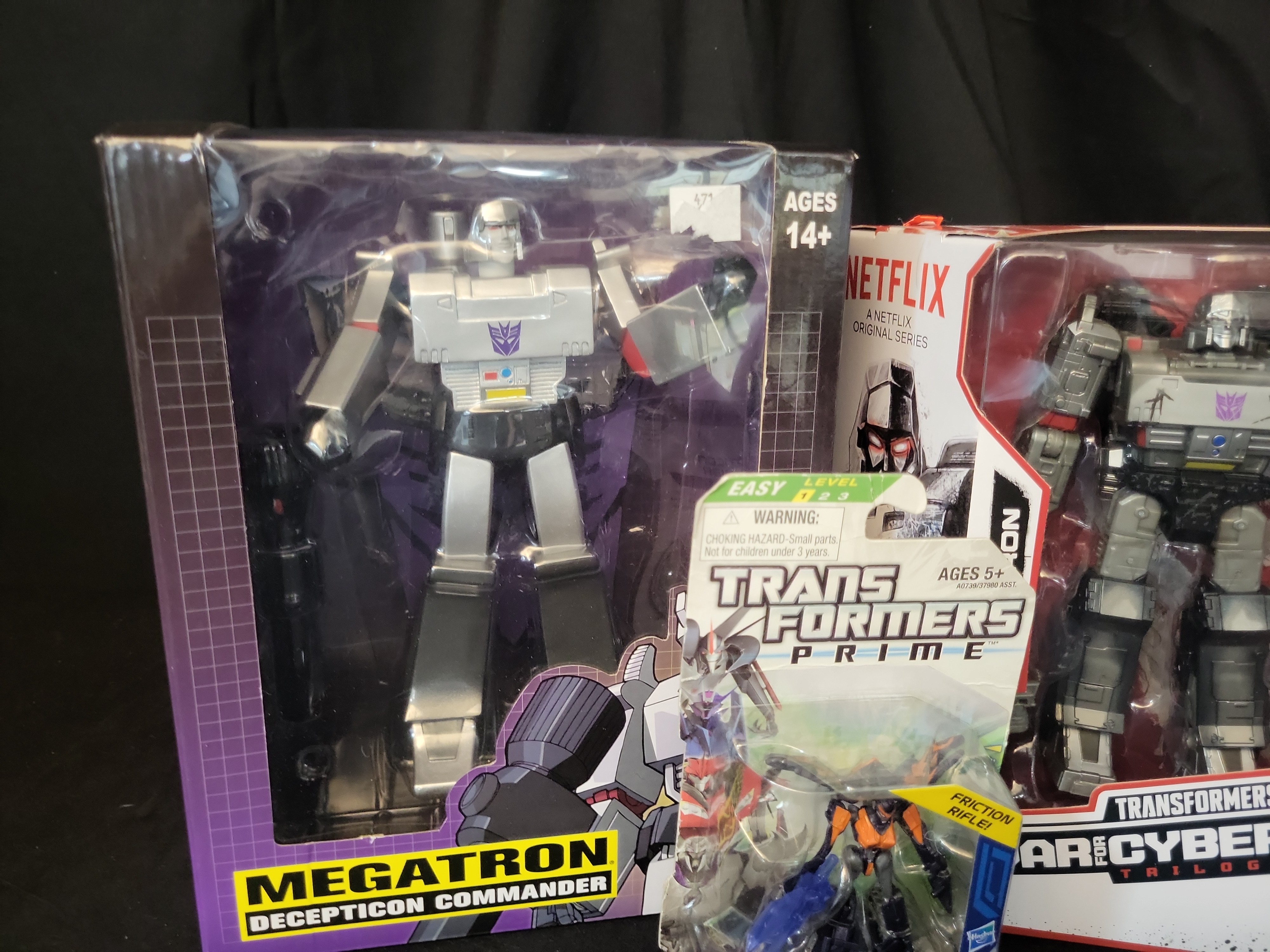 I03502 | A Collection of Four Hasbro and PCS Collectibles Transformers Action Figures in Original Packaging