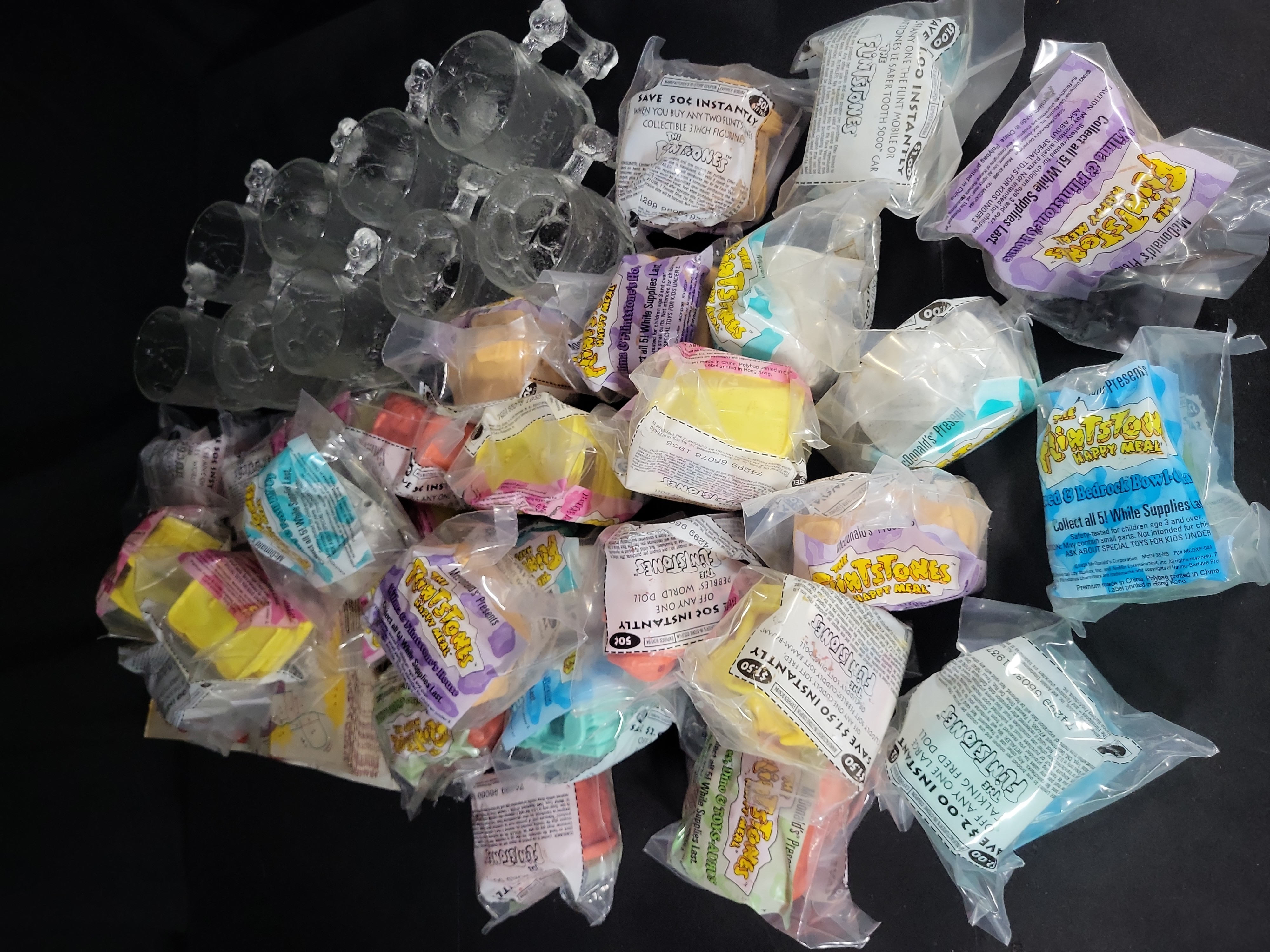 I03176 | A Collection of McDonald's RocDonald's Flintstones Promotional Mugs and Sealed Happy Meal Toys