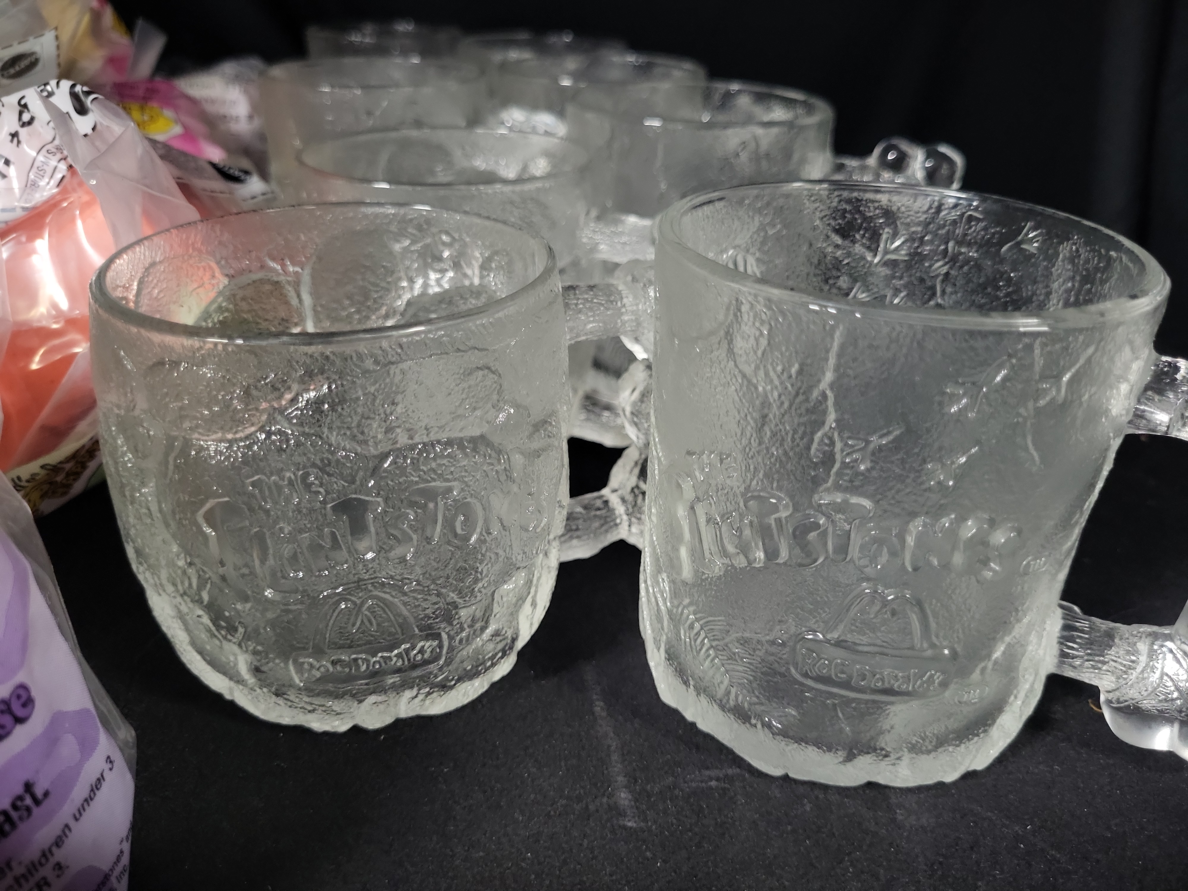 I03176 | A Collection of McDonald's RocDonald's Flintstones Promotional Mugs and Sealed Happy Meal Toys