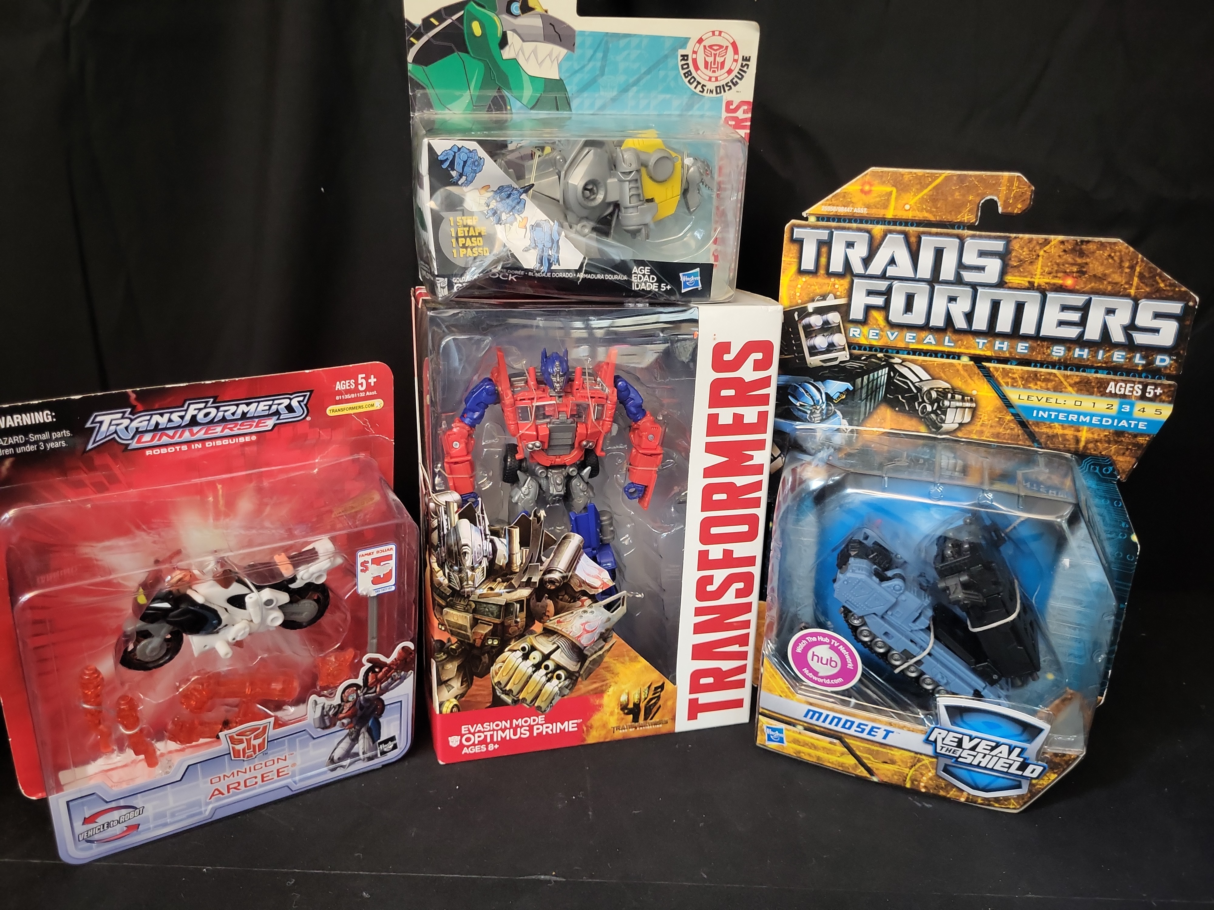 I03505 | Four Hasbro Transformers Action Figures Including Optimus Prime Arcee Mindset and Grimlock in Original Retail Packaging