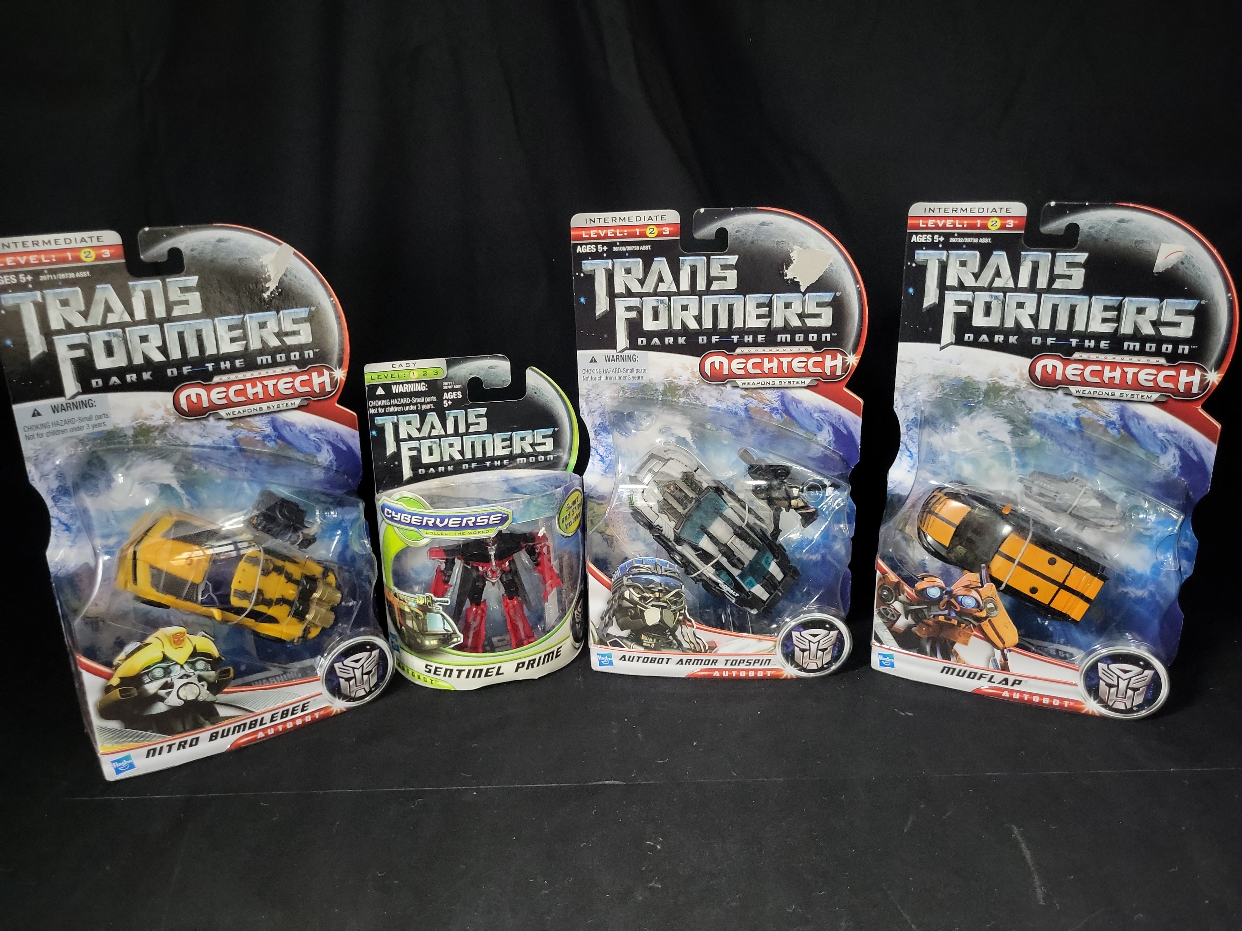 I03525 | A Collection of Four Hasbro Transformers Dark of the Moon Action Figures in Original Packaging