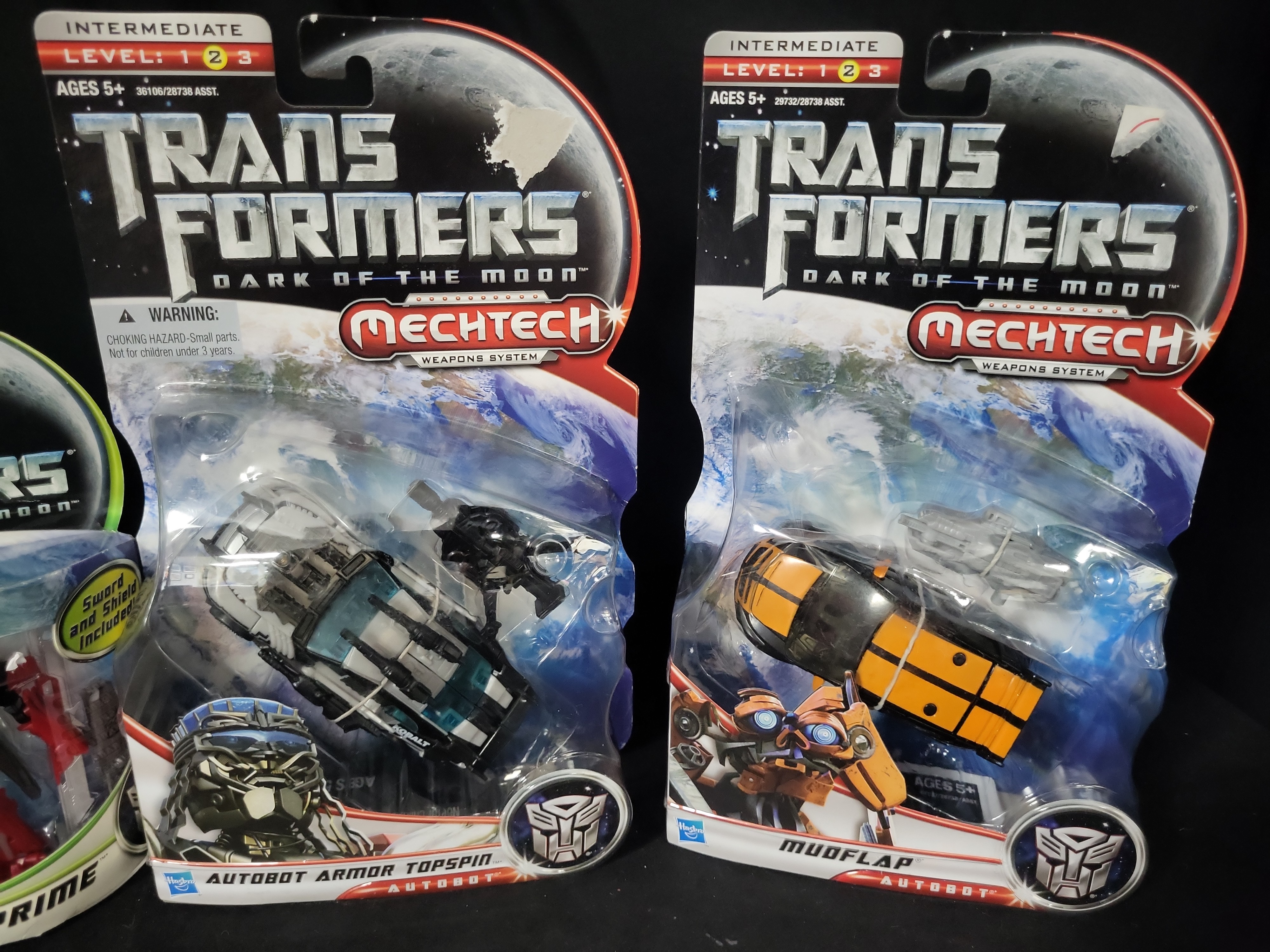 I03525 | A Collection of Four Hasbro Transformers Dark of the Moon Action Figures in Original Packaging