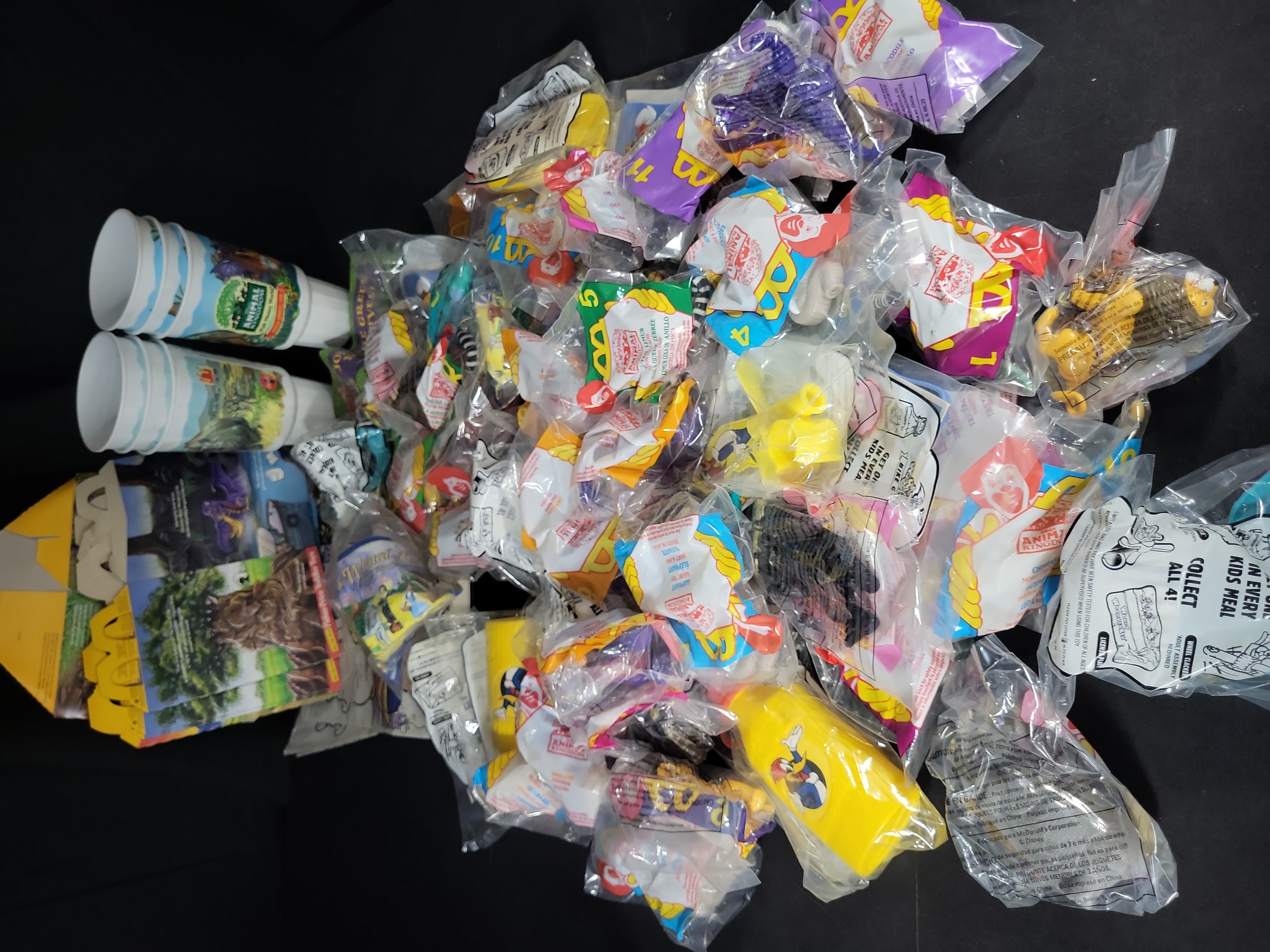 I03174 | An Assortment of Vintage McDonald's Happy Meal Toys and Promotional Ephemera including Disney's Animal Kingdom and Woody Woodpecker