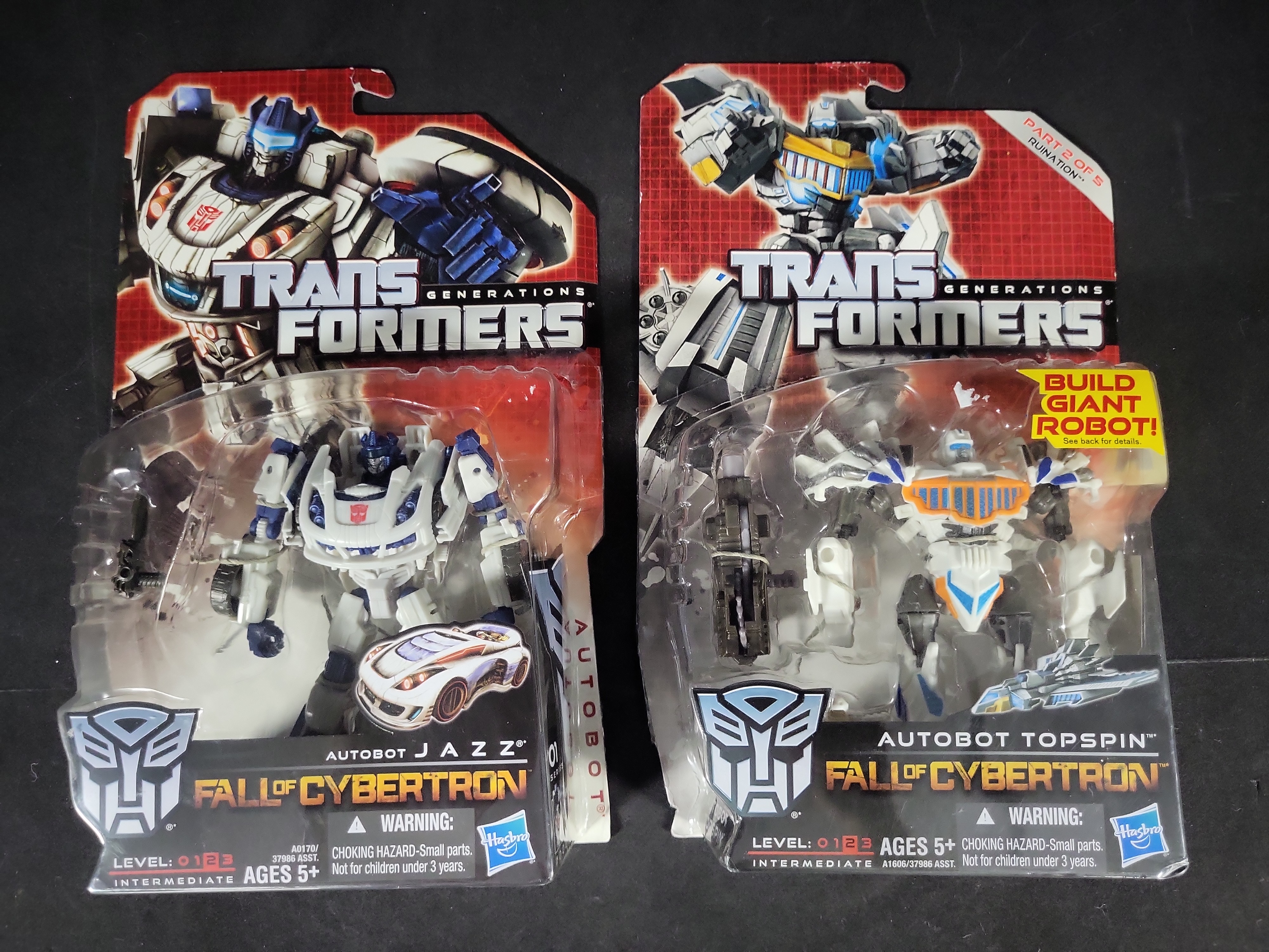 I03521 | A Pair of Hasbro Transformers Generations Fall of Cybertron Action Figures Jazz and Topspin