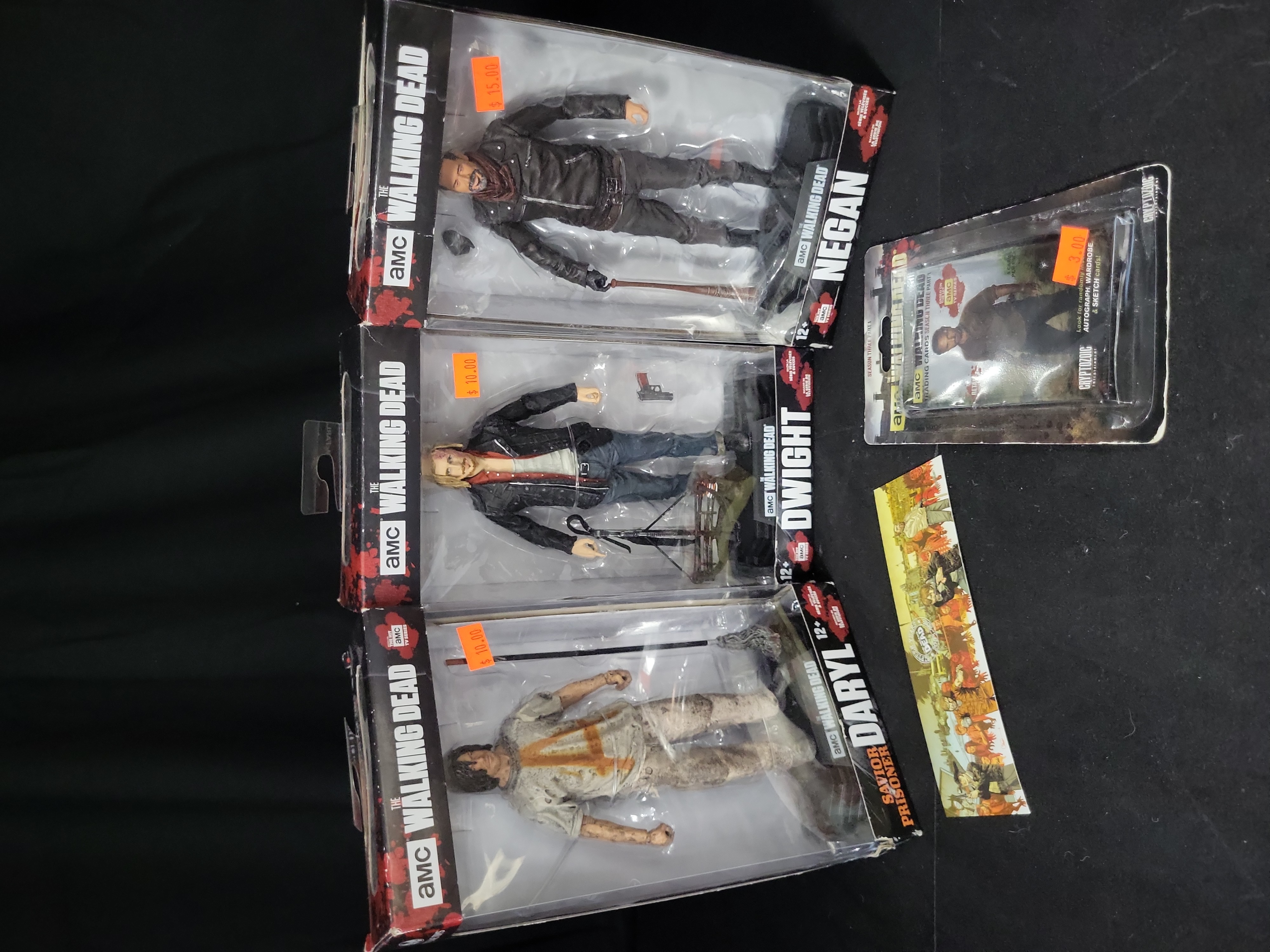 I03529 | Five The Walking Dead Collectible Items Including McFarlane Toys Action Figures and Cryptozoic Trading Cards