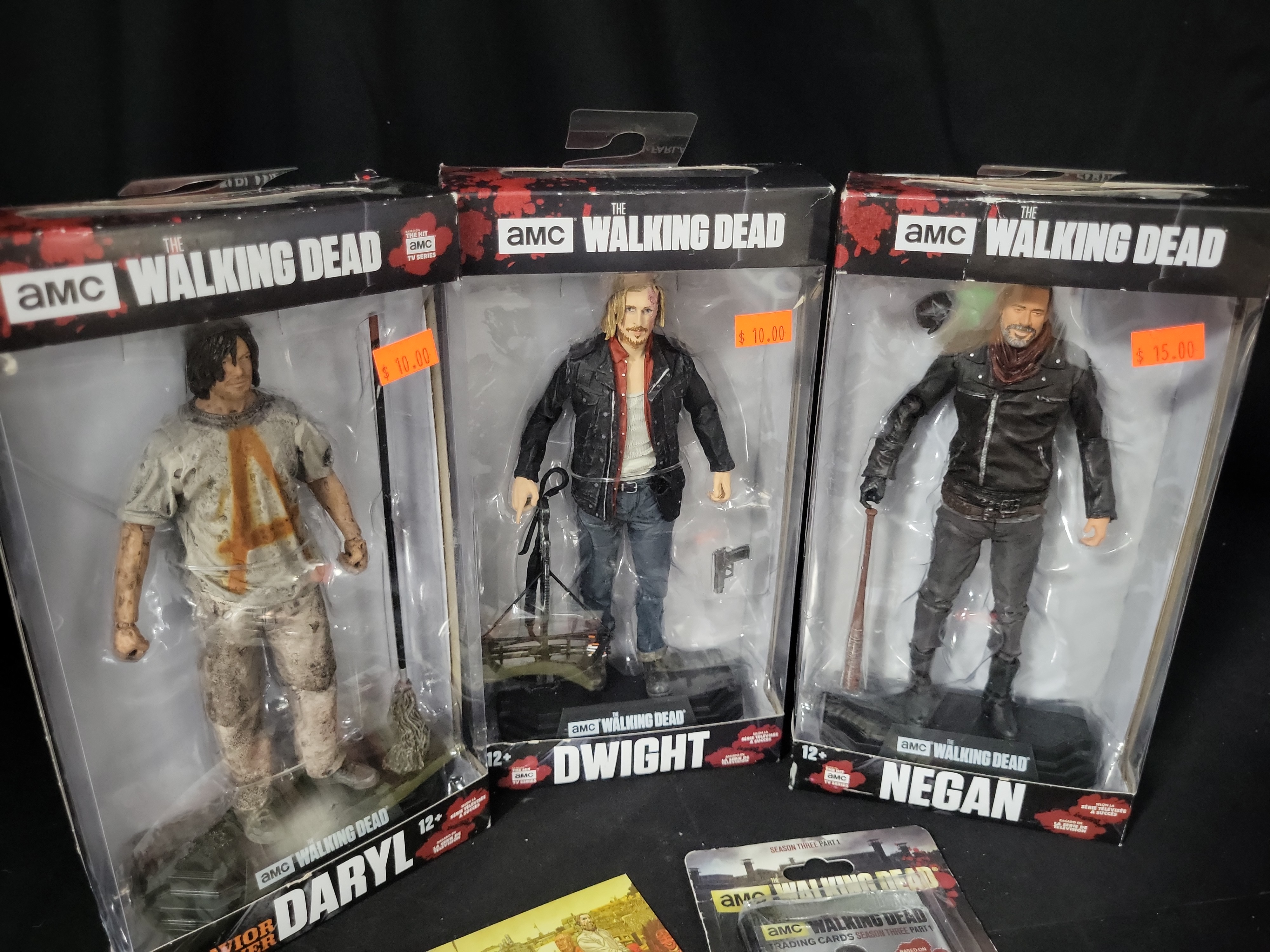 I03529 | Five The Walking Dead Collectible Items Including McFarlane Toys Action Figures and Cryptozoic Trading Cards