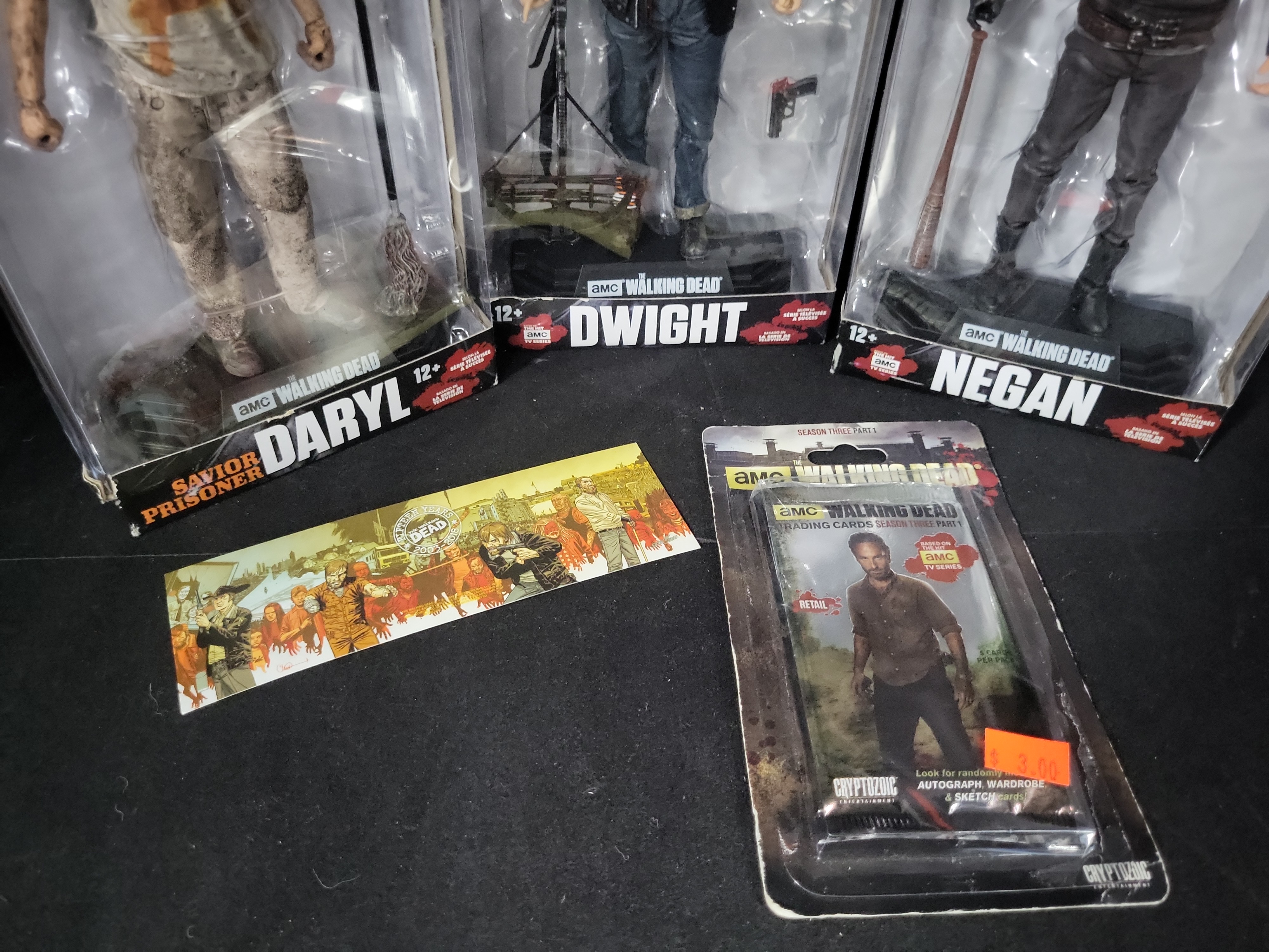 I03529 | Five The Walking Dead Collectible Items Including McFarlane Toys Action Figures and Cryptozoic Trading Cards