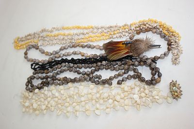 Necklaces made from shells, a feather pin etc