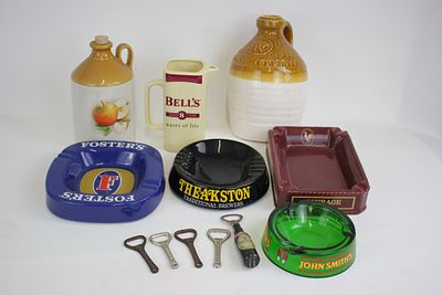 A selection of pub ashtrays, bottle openers and other Breweriana