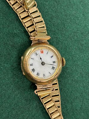 An early 20th century yellow metal gold ladies wristwatch diameter 24 mm, on plated strap