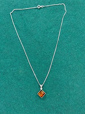 A white metal and amber necklace
