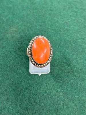 A yellow metal Ladies dress ring with an orange stone Weight 6.06 gm size L