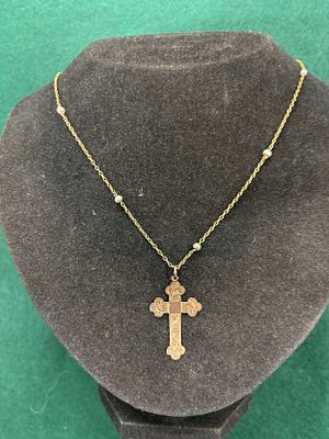 A yellow metal 9ct Gold Cross on a 15ct gold chain with interspaced beads The chain being c18" 