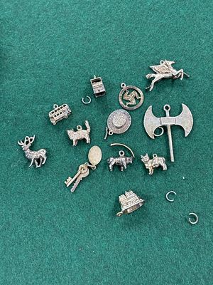 A collection of White metal charms