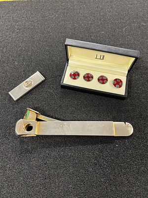 A gentleman's lot comprising two cigar cutters, one being silver weighing 12.86 gm, the other 