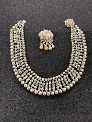 A beaded necklace with a similar German made brooch