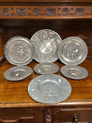 Seven pewter, white metal decorative plates