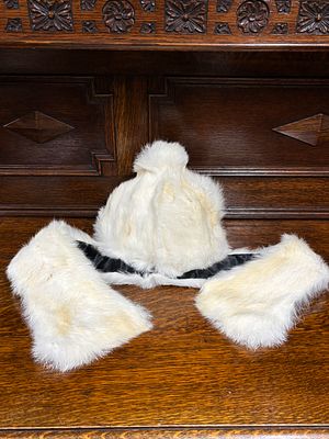 A white fur hat with matching scarf