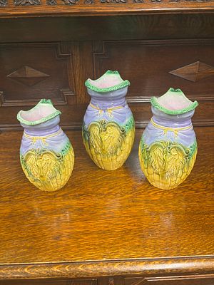 Three graduated Majollica style corn jugs