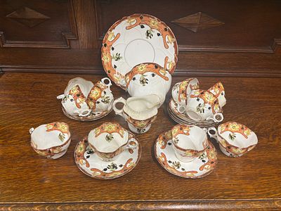 A quantity of cups and saucers, milk jug, sugar bowl and cake plate marked Rena - A.P. Co to 