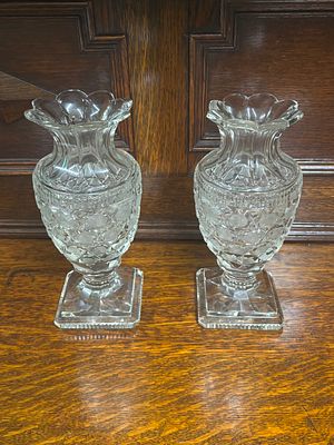 A pair of cut glass urns measuring 22 cm tall