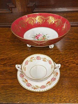 A Coalport fruit bowl on three feet together with a Royal Worcester Montpellier two handled cup 