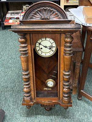 An early 19th century walnut Vienna wall clock having crest and hearth pillar decoration, in 