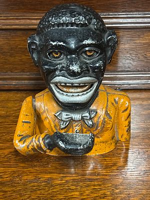 A traditional style money box with description on reverse