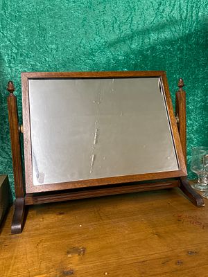 An early 20th Century oak framed toilet mirror with acorn finials