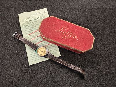 A ladies Kelton 21 wristwatch with leather strap, original box and guarantee dated July 1951. 