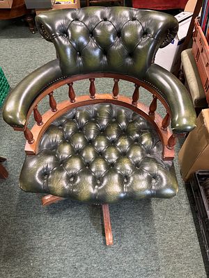 A reproduction Captain's, office swivel armchair with green leather upholstery