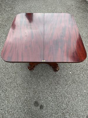 A 19th Century William IV mahogany tea table, with fold over swivel top on a melon pedestal and 
