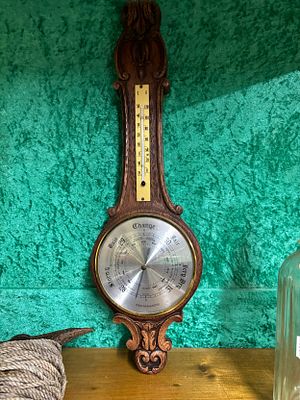 A mid 20th century oak frame aneroid barometer