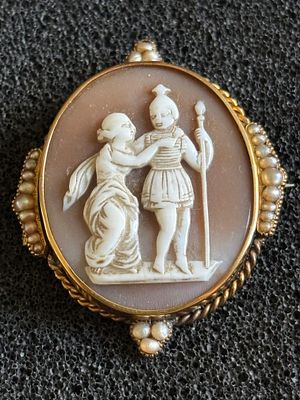 A cameo with two figures in a gold mount decorated with seed pearls weighing 8.44 gm