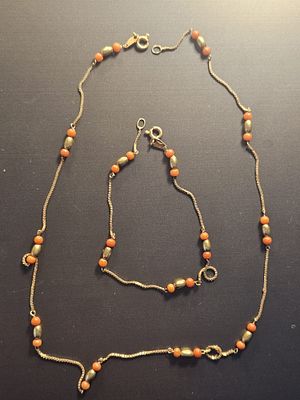An 18ct gold and coral necklace, length 40cm and a matching bracelet, length 19cm. Overall 