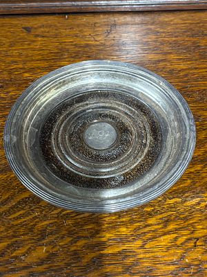 A HM silver bottle coaster dated 1987 with AEB inscribed to centre